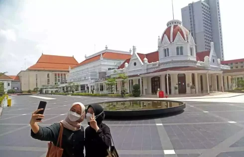 Dua remaja berfoto di Alun-alun Kota Surabaya, lokasi puncak gelaran Anugerah Pewarta Foto Indonesia (APFI) 2023